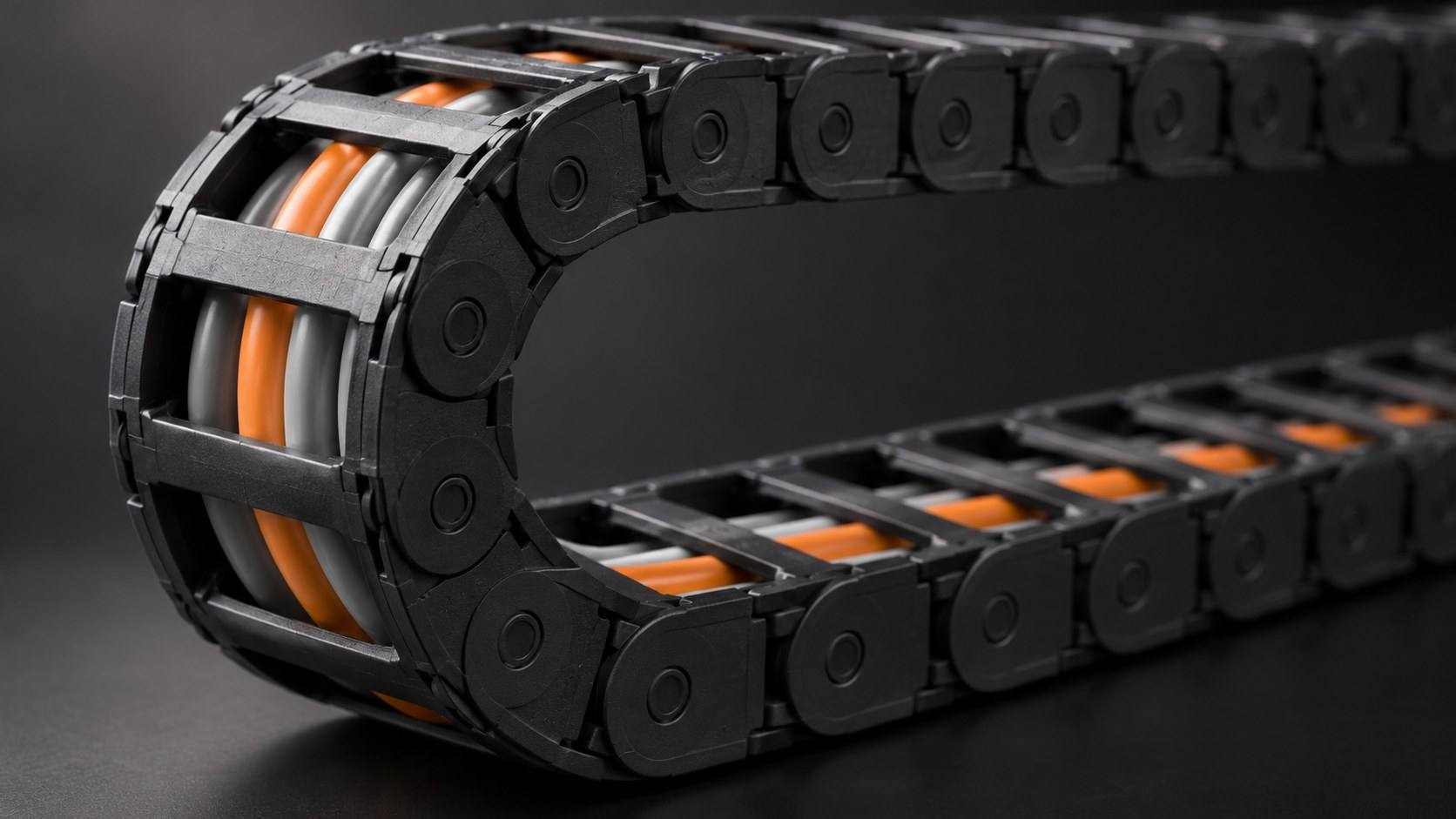 Colored cables carried in a black plastic cable drag chain.